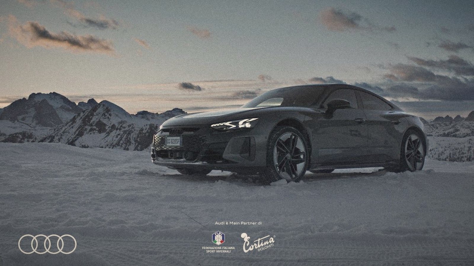 Audi e-tron GT in the snow at Cortina, the Dolomites behind